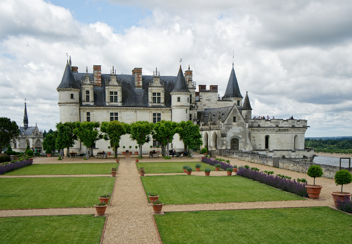 a large castle with a garden in front of it